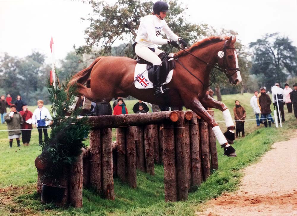 Fiona Stuart jumping a large cross country jump when eventing