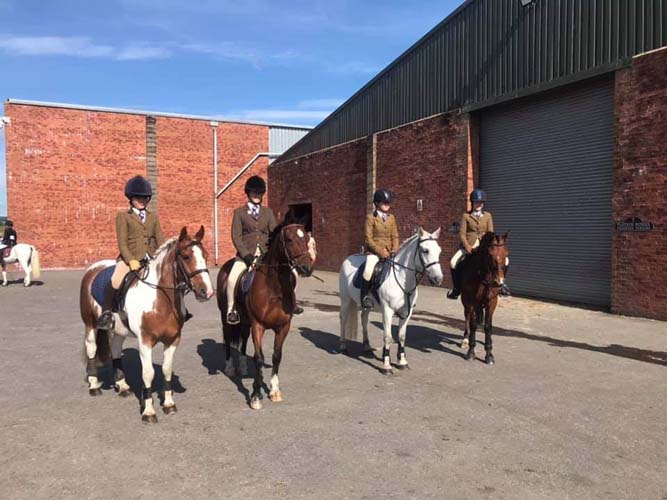 Horses and their riders at a show from Tullochan Stables near Glasgow